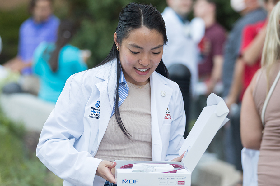 A first-year medical student opening their stethoscope box with excitement