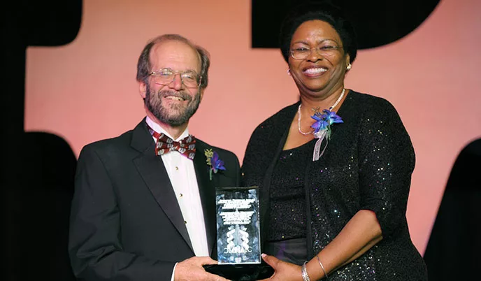 Robert Golden receives and award from Valerie Williams