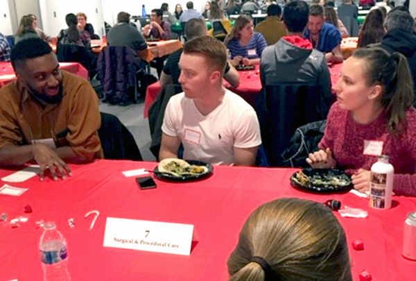 People chatting at a table during an "Unfazed" event