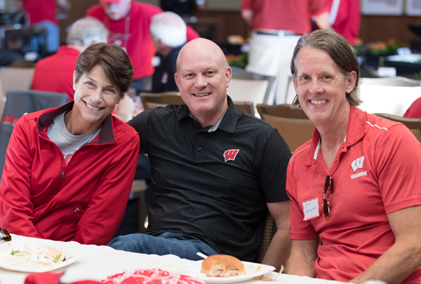 Three people smiling at the WMAA Homecoming Weekend dinner