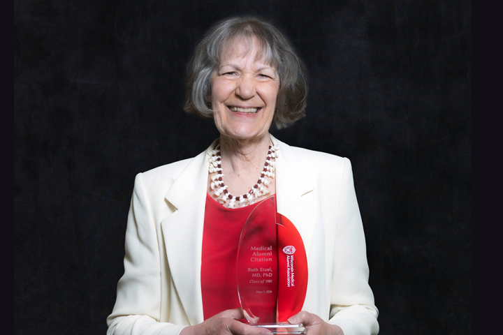 Ruth Etzel holding an award