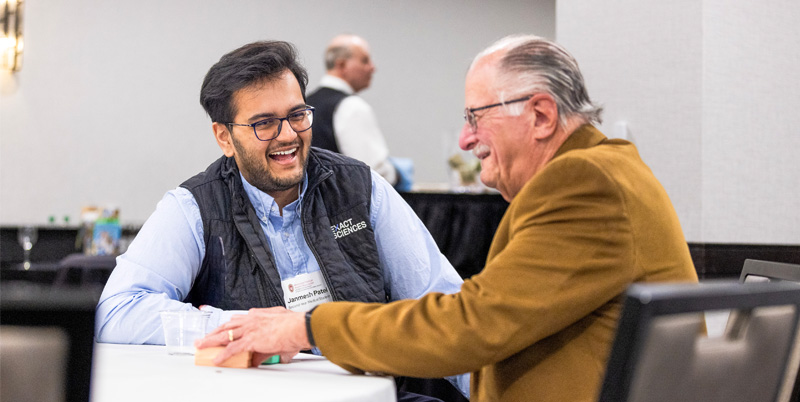 Janmesh Patel and Lee Tyne laughing and chatting