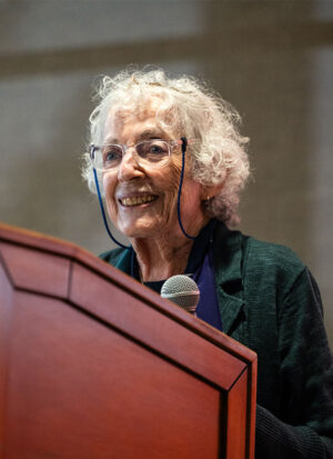 A woman standing at a podium with a mic
