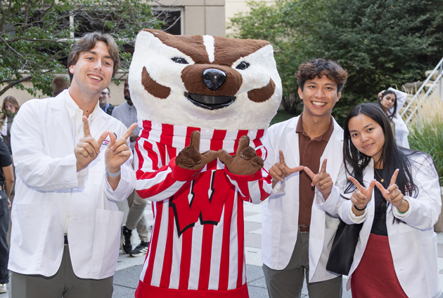 Three students with Bucky Badger