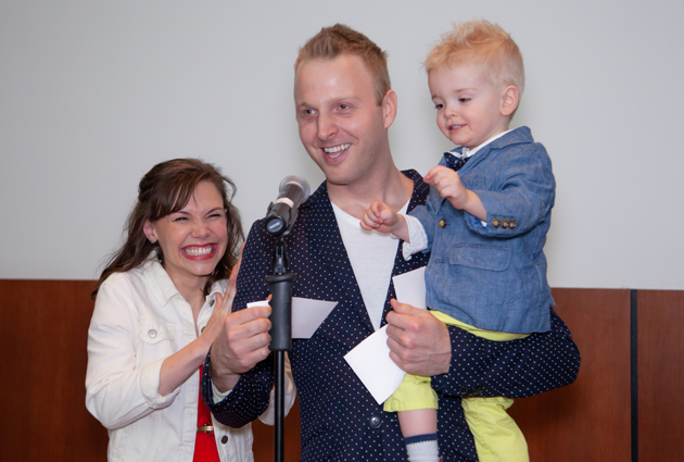 A man, woman, and young child look happy at a Match Day event