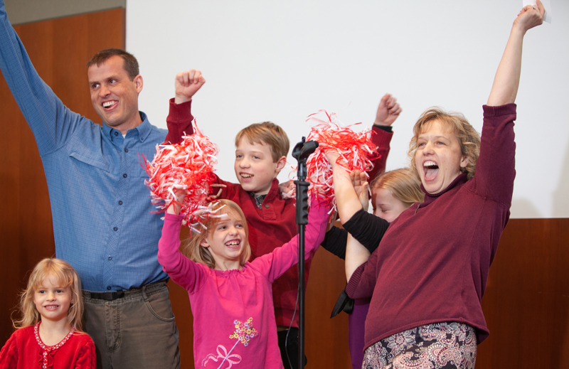 Two adults and four children cheer at a Match Day event