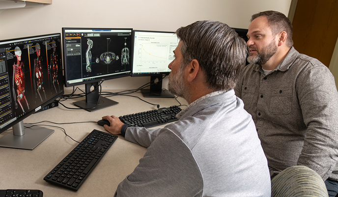 Bryan Bednarz and Tyler Bradshaw sitting at a computer