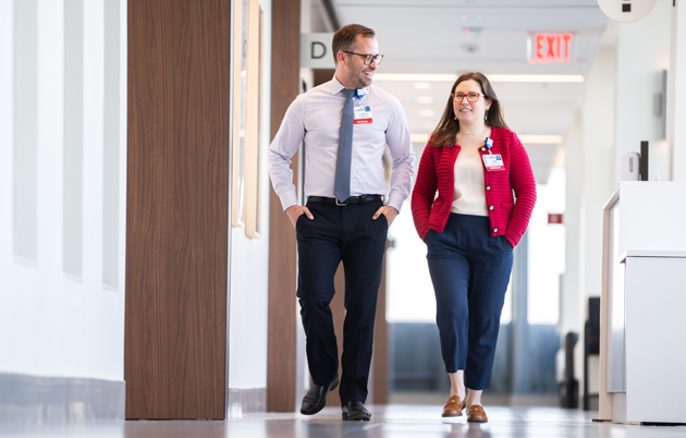 Doctors consult in a sunny hallway at UW Health Eastpark Medical Center.
