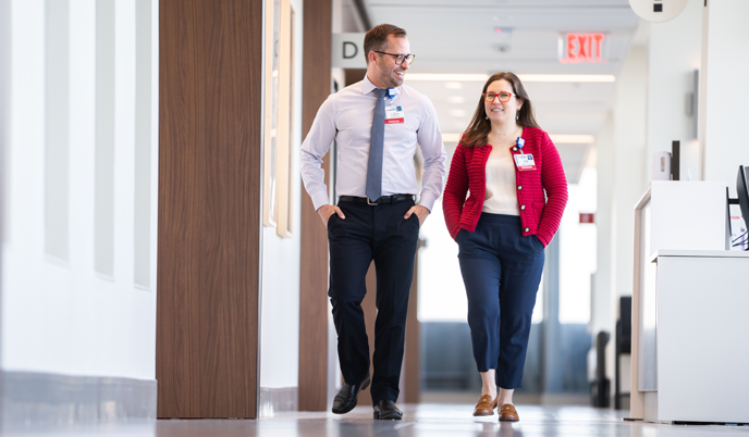 Doctors consult in a sunny hallway at UW Health Eastpark Medical Center.