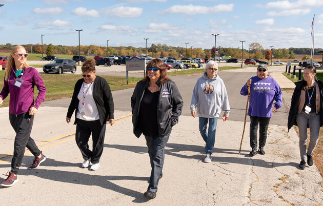 A group of people walk outside