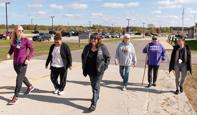A group of people walk outside