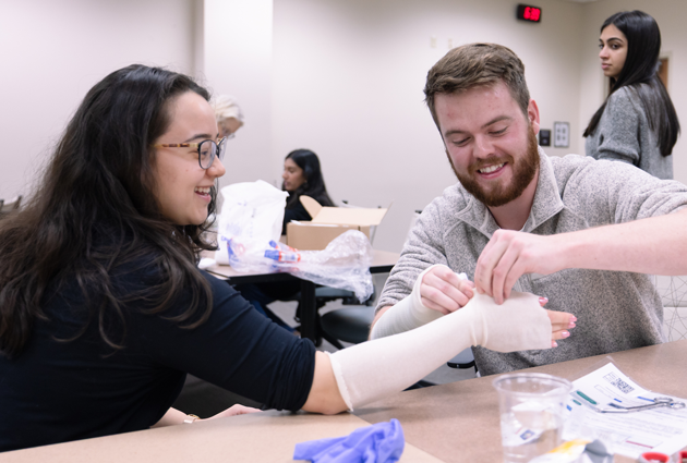 Two people participate in a procedures fair splint exercise