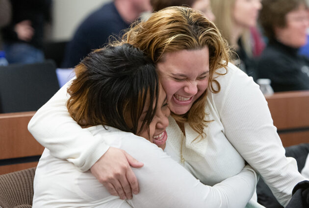 Two women hug during a Match Day event