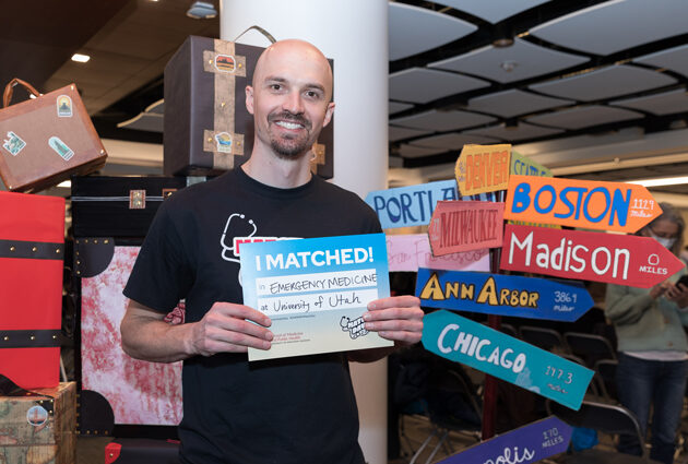 A man poses with a sign during the 2023 Match Day event