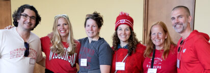 A group of six people together at an Alumni event