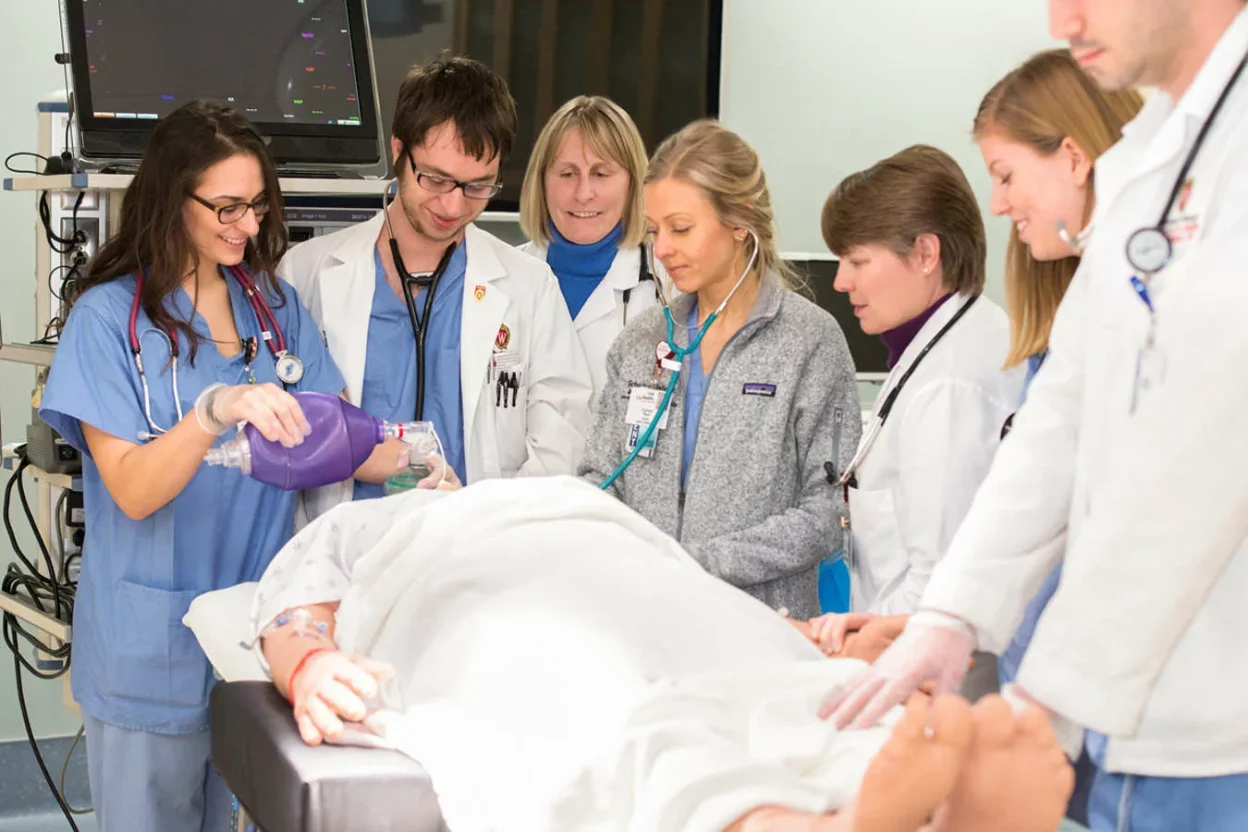 Students and physicians around a surgical table