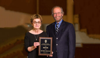 Eileen Smith accepted the Belzer Award from Dean Robert Golden