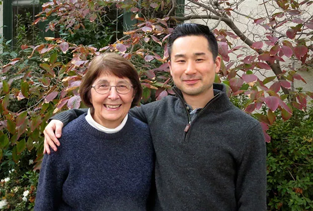 An alum and student smiling together for the camera