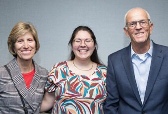A scholarship recipient smiling big with Linda and Thomas Kloosterboer
