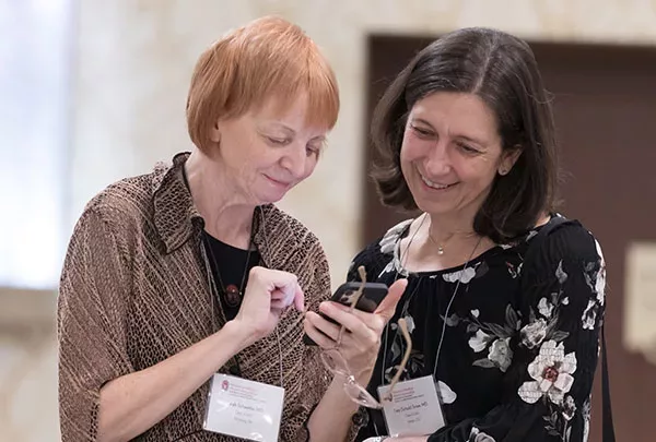 Sarah Schaettle, MD '02 and Tara Snow, MD '02 catch up at WMAA Homecoming 2022