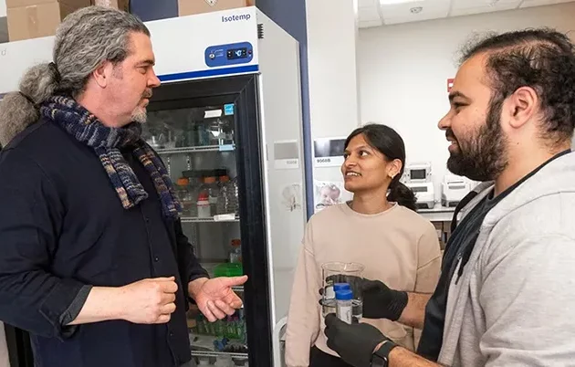 Chapman in discussion with other researchers