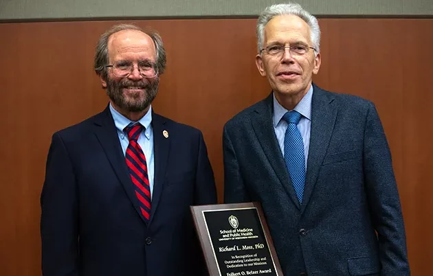 Dean Golden presents Richard Moss with an award
