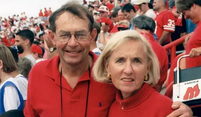 A smiling middle-aged couple at a Badger game