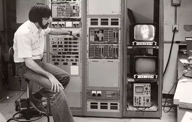A man working with large radiological equipment decades ago