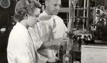 Two scientists working in a lab decades ago