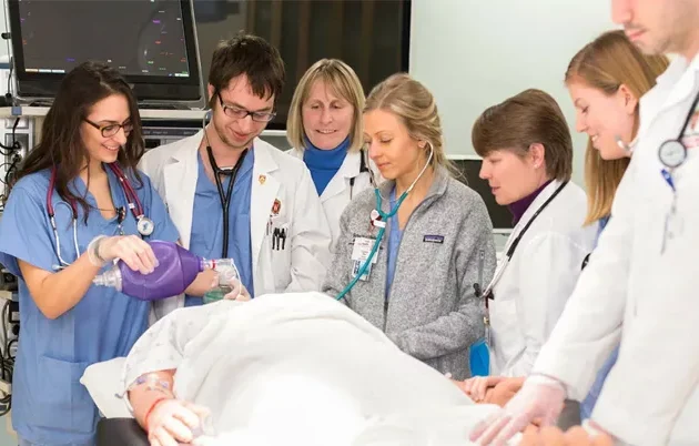 Students and physicians around a surgical table