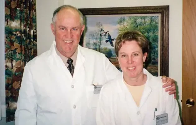 David Morris and Mary Morris smiling at the camera in their white coats