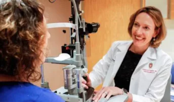 An ophthalmologist smiling at a patient
