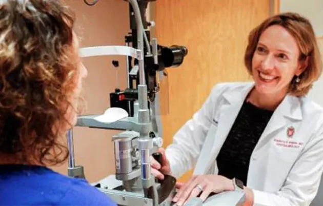 An ophthalmologist smiling at a patient