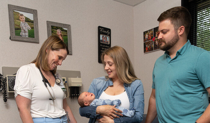 Jenna Sebranek meets with the parents of a baby she delivered in an exam room