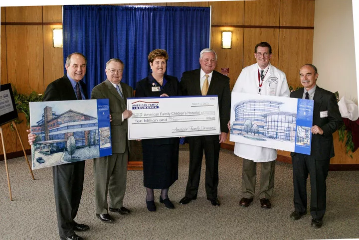 People posing with a large check 