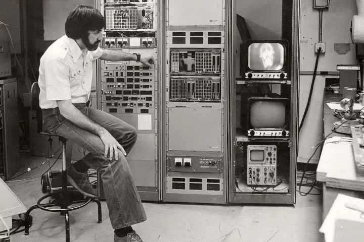 Physicist Charles Mistretta interacts with large radiological equipment