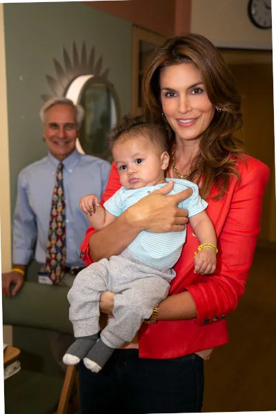Cindy Crawford holding a baby and patient at the children's hospital