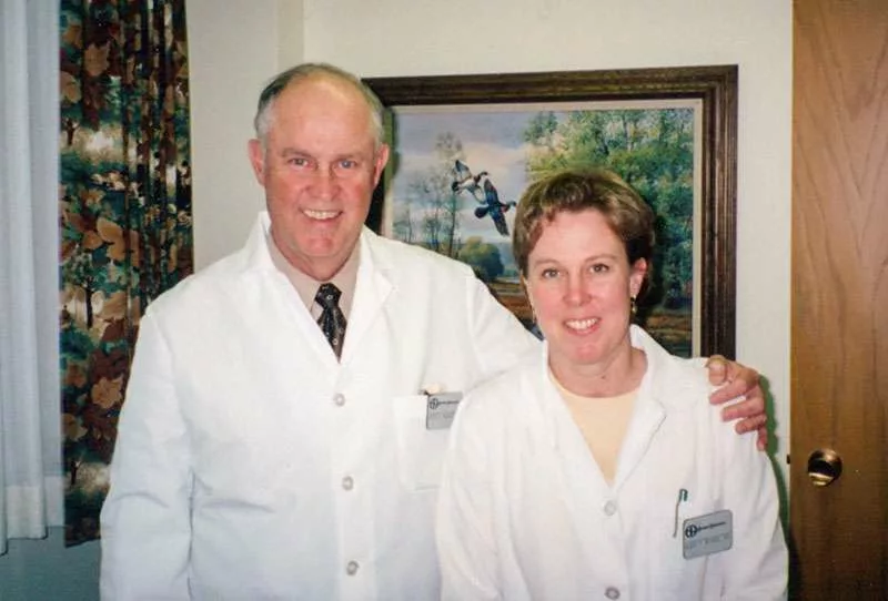 David Morris and Mary Morris smiling at the camera in their white coats