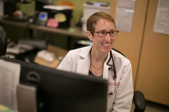 Beth Potter smiling in her white coat