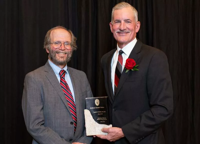 Robert Golden presenting Patrick McBride with an award