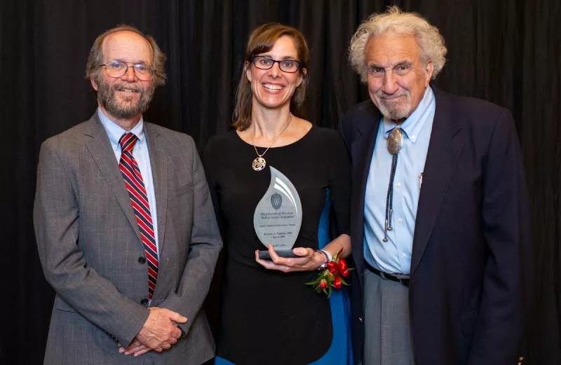 Robert Golden, Kristen Nadeau and Michael Kappy, MD ’67, PhD ’67 posing with an award