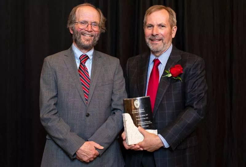 Robert Golden presenting Pierre Tariot with an award