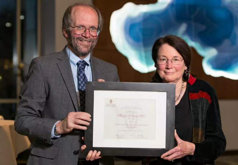 Mary Wilson receiving an award from Dean Robert Golden