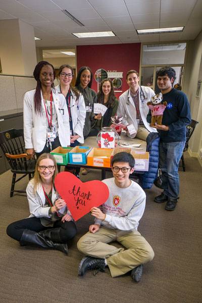 A group of students posing with thank-you notes
