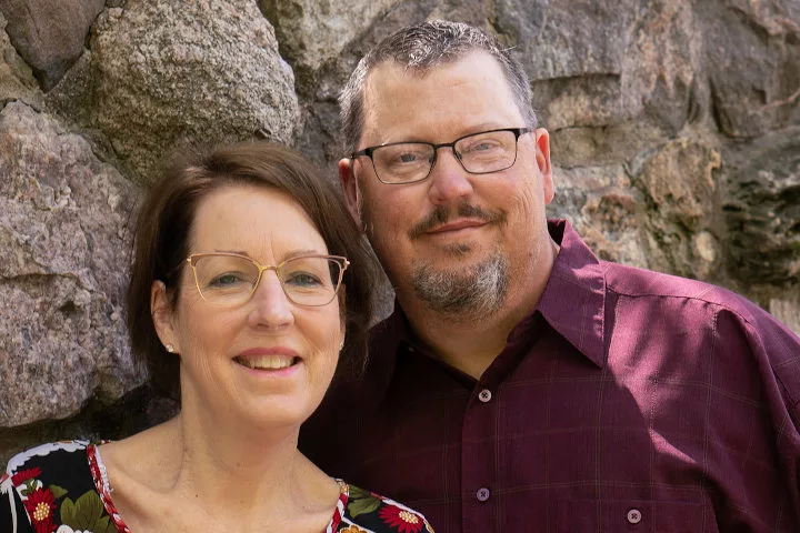 Two middle-aged siblings and transplant recipients posing together for the camera