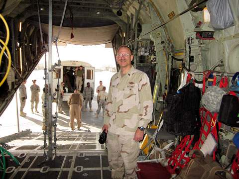 A soldier, Rom Stevens, standing in a military cargo plane