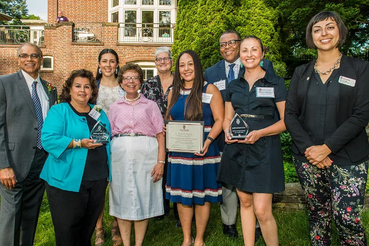 University and community leaders posing for a picture to celebrate winning an award