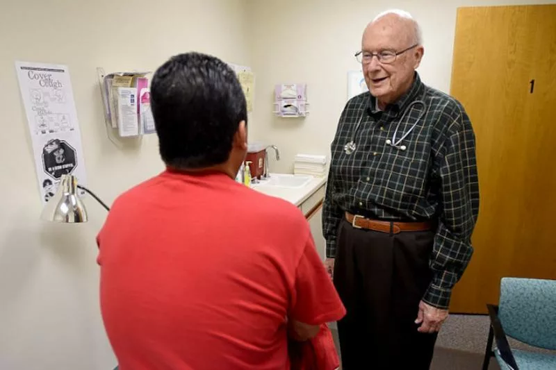 A patient and physician in an exam room